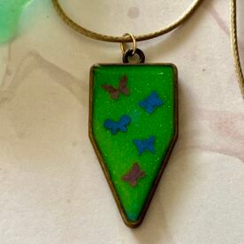 Necklace- Misa Cornus Drop Pendant with Beige Cord Chain- Green base, Pink & Blue Butterflies 4 IMG 6755