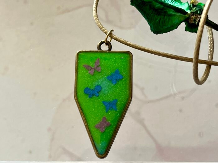 Necklace- Misa Cornus Drop Pendant with Beige Cord Chain- Green base, Pink &  Blue Butterflies